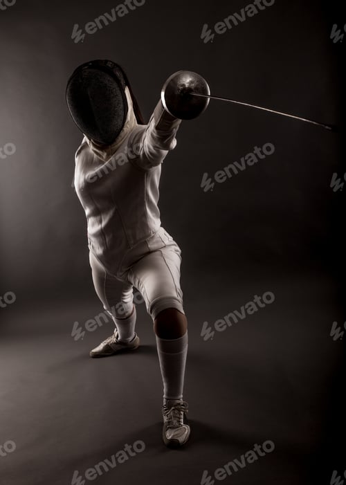 Preview: Portrait of woman wearing white fencing costume practicing with the sword.