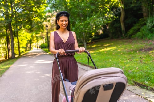 Preview: Latin mother walking with baby stroller in park