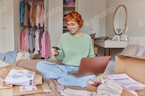 Preview: People online shopping and purchasing concept. Serious ginger woman gets salary going to spend money