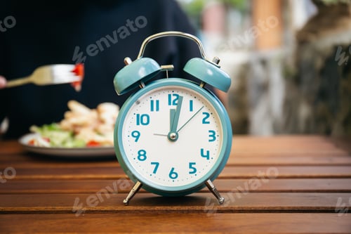 Preview: Close-up, alarm clock on a blurred food background.