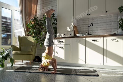 Preview: Boy goes in for sports or yoga at home. child make workout exercises in the room. Kids yoga