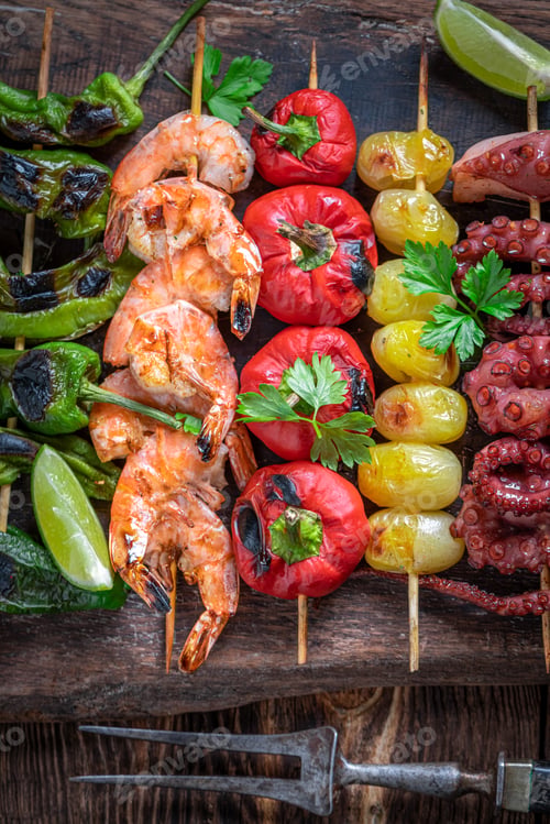 Preview: Healthy grilled skewer cooking on grill with metal grate.