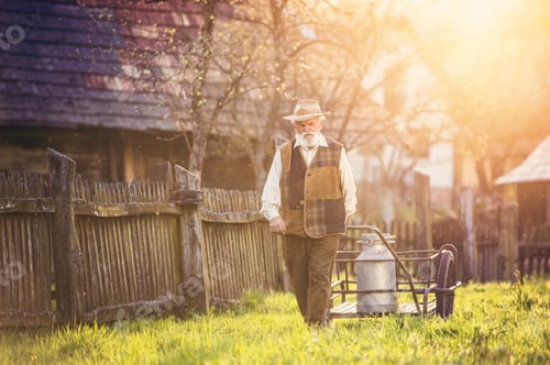 Preview: Senior man with milk kettle