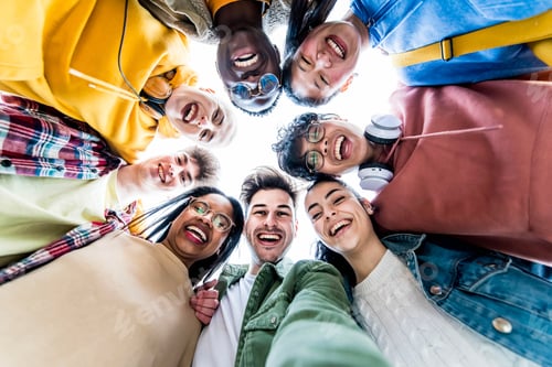 Preview: Multiracial group of young people standing in circle smiling at camera