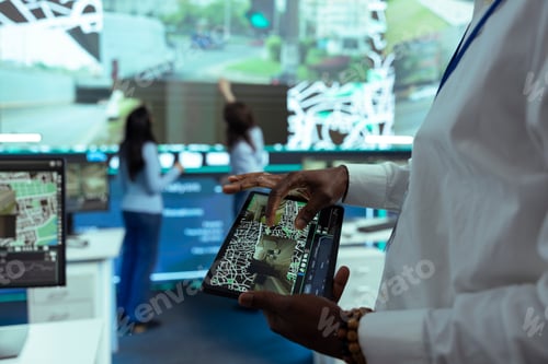 Preview: African american manager using a tablet to monitor delivery trucks around town