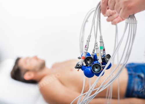 Preview: Doctor holding ECG electrodes for heart diagnostic over mature man. Medical equipment for