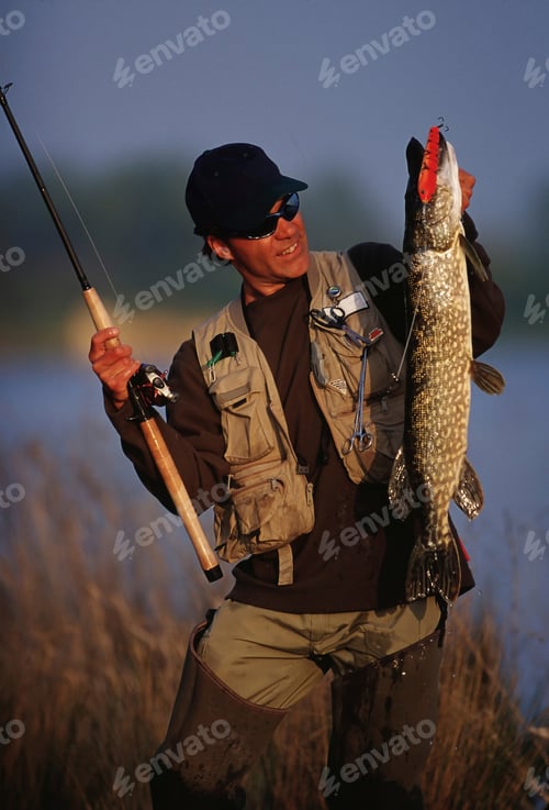 Preview: Angler holding a rod and a fish.