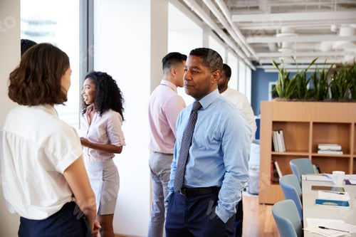 Preview: Group Of Business Colleagues Chatting In Office After Meeting