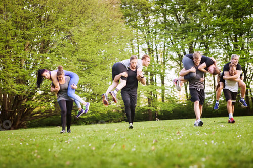 Preview: Man and woman carrying friends while running on field