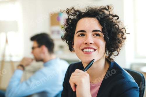 Preview: A portrait of young businesswoman with colleagues in a modern office.
