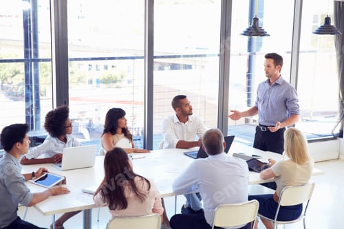 Preview: Businessman presenting to colleagues at a meeting