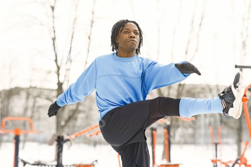 Preview: African american man doing exercise on winter day