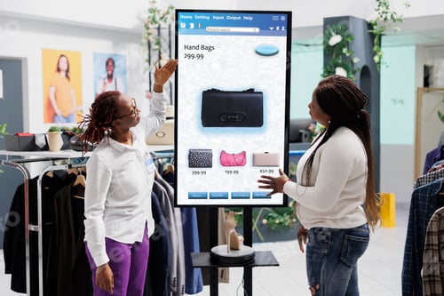 Preview: Woman employee showing clothes