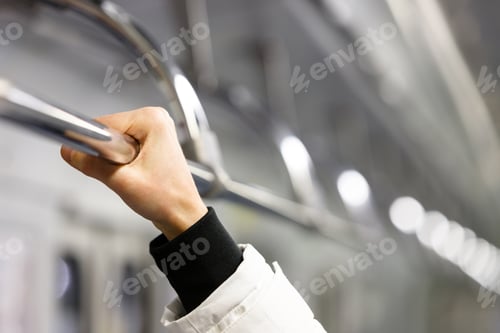 Preview: Passanger holding handrail in subway train