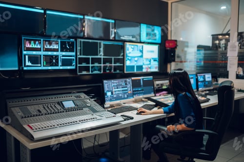 Preview: Middle aged woman using equipment in control room on a tv station