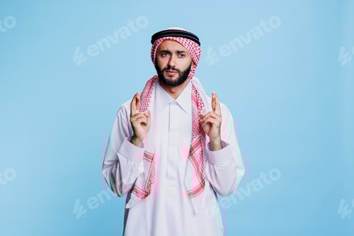 Preview: Muslim man crossing fingers in belief