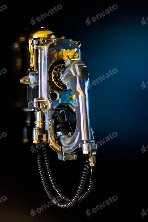 Preview: Vertical shot of an old vintage telephone on a black wall