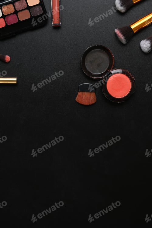 Preview: Overhead shot of feminine desk with with lipsticks, eye palette, face powder, brushes.