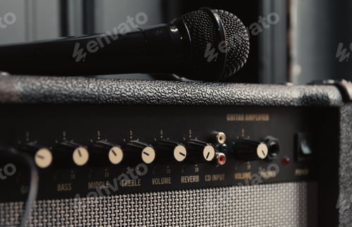 Preview: Closeup shot of a microphone on a retro guitar amplifier in a studio
