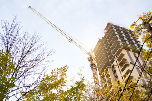 Preview: Construction of a multi-storey apartment building in the city. A crane near a skyscraper.