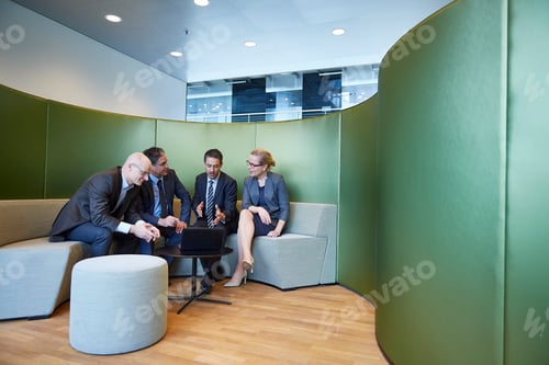 Preview: Businessmen and businesswoman meeting on office sofa