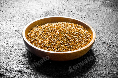 Preview: Mustard in a wooden plate.