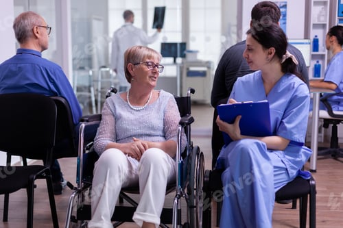 Preview: Nurse filing documents while talking with disabled senior woman