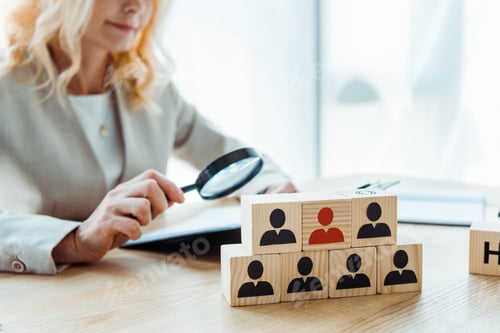 Preview: selective focus of wooden cubes near blonde recruiter
