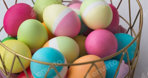 Preview: Colored Easter eggs in a basket on the table