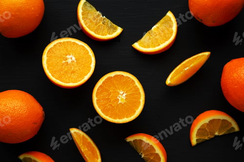 Preview: Raw Organic Orange Fruit on a black background, top view.