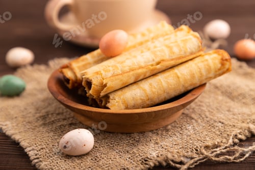 Preview: Waffles with caramel on brown wooden, linen textile, cup of coffee, side view, selective focus