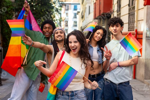 Preview: Young activists holding rainbow flags celebrating gay pride in the city
