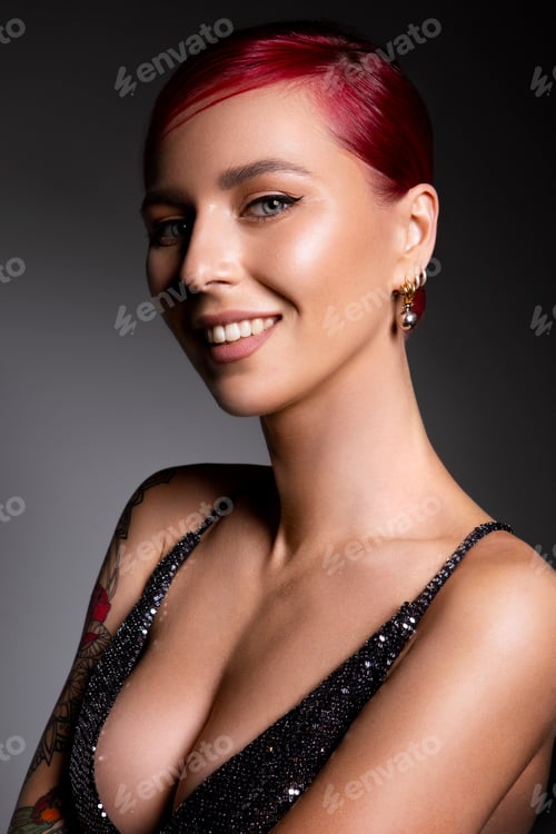 Preview: Beautiful woman with red hair. Flat grey background. Woman with tatoo