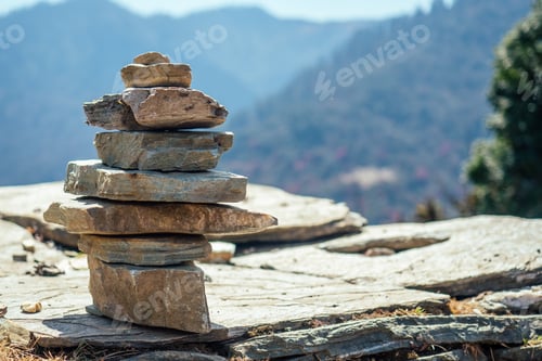 Preview: Pyramids of stones against the background of mountains.