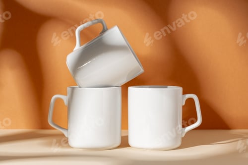 Preview: White ceramic mugs on peach background with shadows