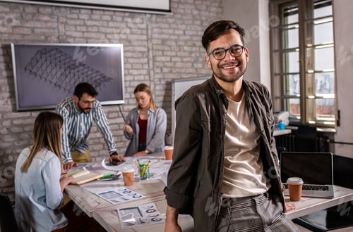Preview: Portrait of confident young male leader standing in office.