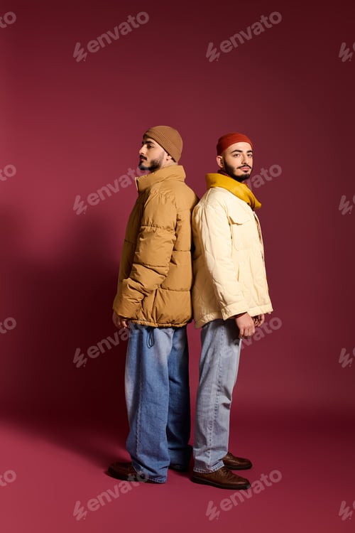 Preview: Stylish twin brothers showcase unique fashion choices in bold colors and elegant poses