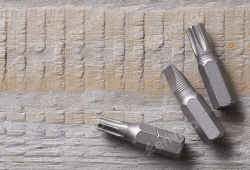 Preview: Different screwdriver bits on wooden table, top view. Space for text