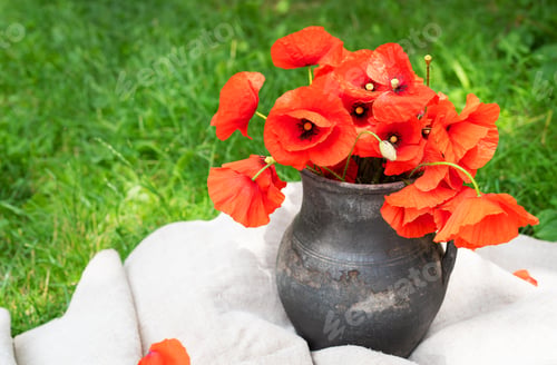 Preview: Bouquet of wild flowers of red poppies in an old clay jug. Summer photo, rustic style, close-up.