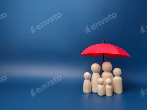 Preview: Small wooden toy figurines against the miniature red umbrella against a blue wall - copy space