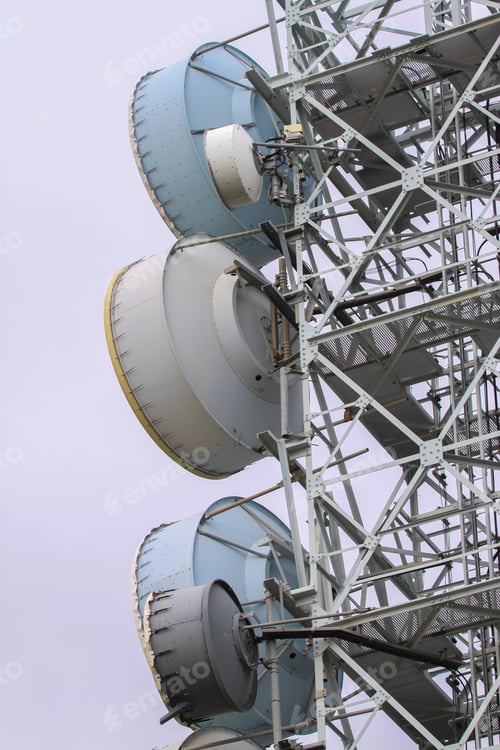 Preview: Vertical shot of a microwave antenna with the skies in the background