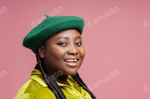Preview: Smiling, happy African American woman with stylish braids hair wearing green beret and casual outfit