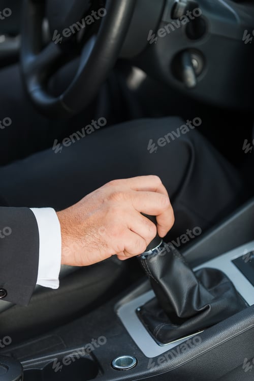 Preview: Driving a car. Close-up of man in formalwear driving car