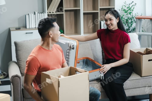 Preview: young couple helps put things in boxes and prepares to move to a new house.