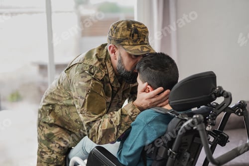 Preview: Military soldier man kissing his son sitting in wheelchair
