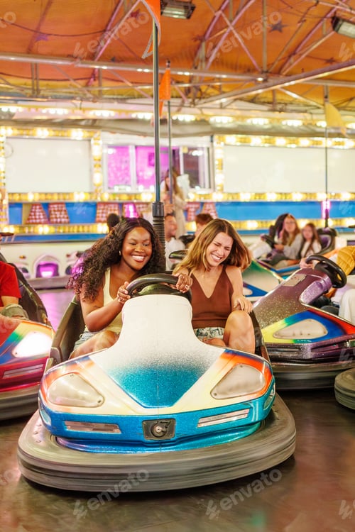 Preview: Two gen z friends enjoying a bumper car ride at a night fair