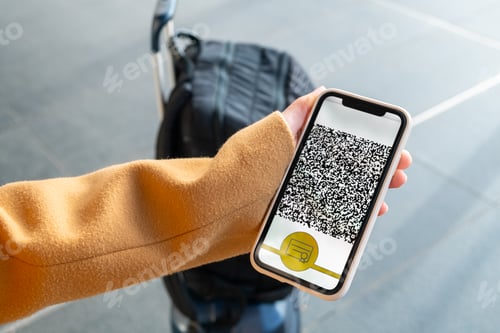 Preview: Passenger shows QR-code of digital airplane ticket on phone