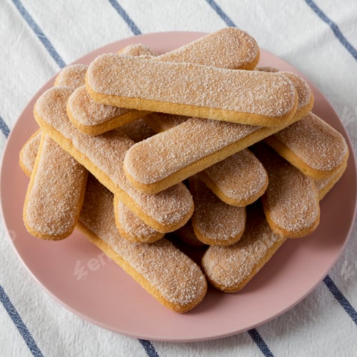 Preview: Savoyardi biscuits on a pink plate, low angle view. Closeup.