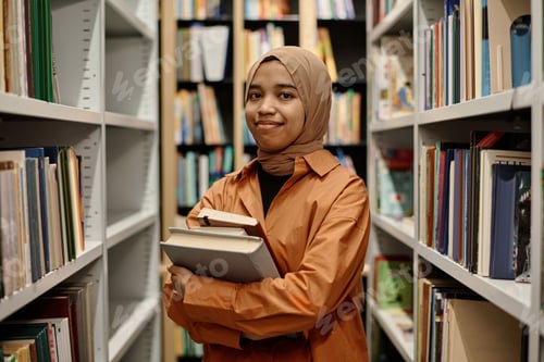 Preview: Cheerful Muslim Girl With Books In Library