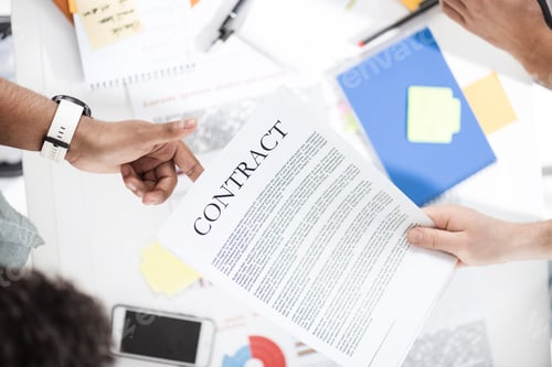 Preview: Overhead view of businessmen holding contract above table with papers